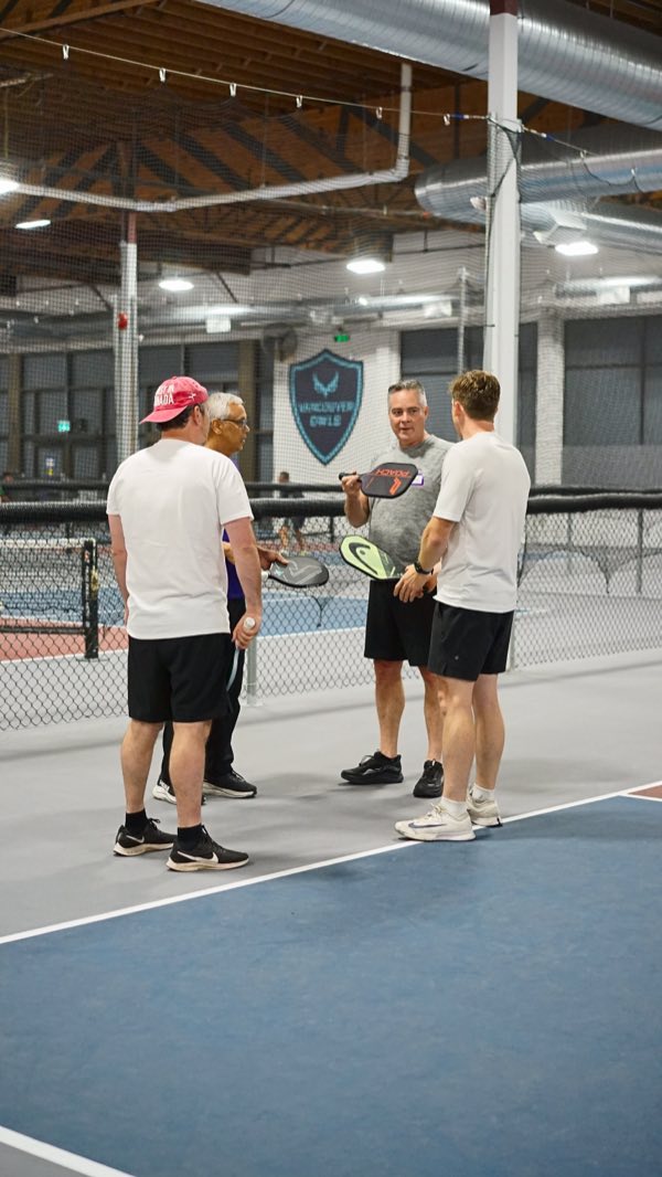 A few players linger on the court after the last game, too busy talking to leave.